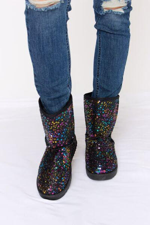 a pair of jeans with a pair of black boots with multicolored sequin