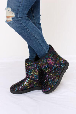 a pair of women's boots with colorful sequins
