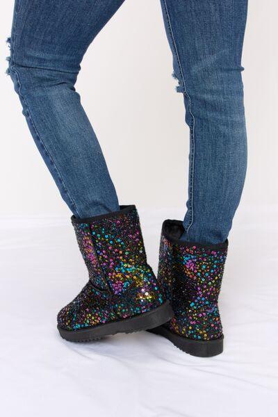 a pair of women's boots with colorful sequins