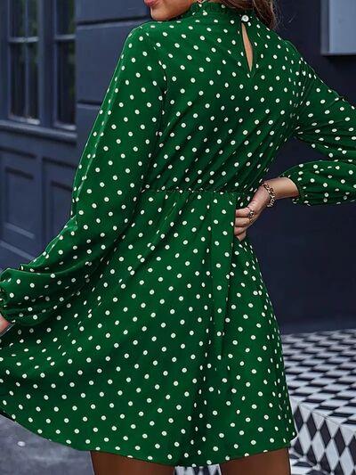 a woman wearing a green polka dot dress