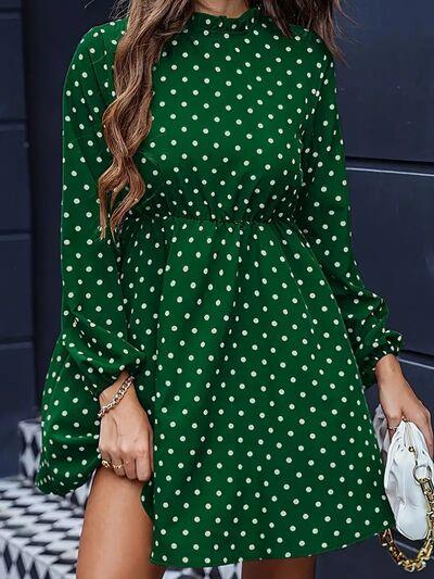 a woman wearing a green polka dot dress