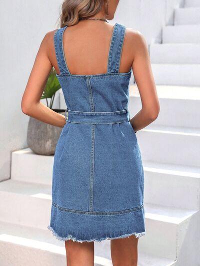 a woman in a denim dress standing on stairs