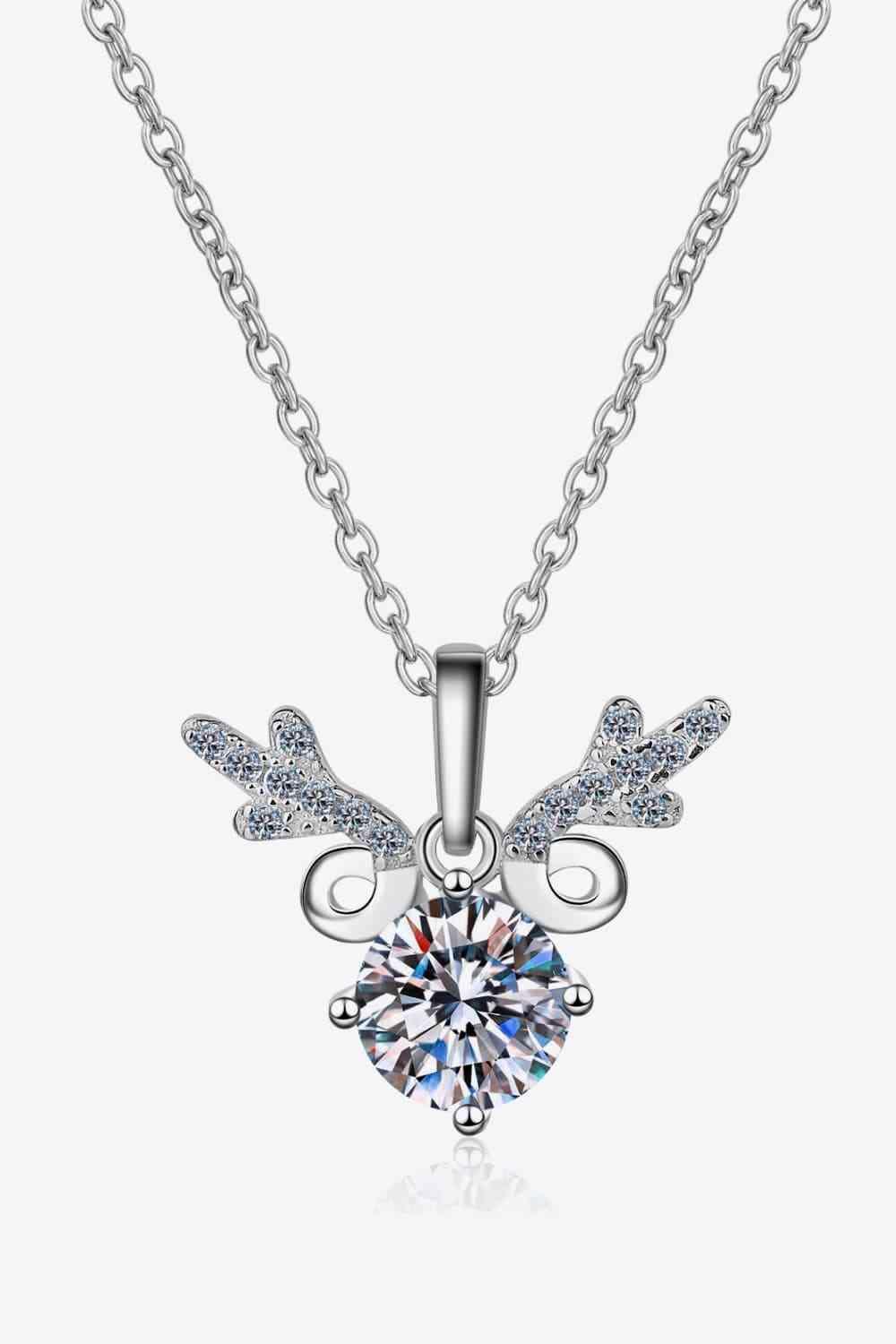 a necklace with a heart and wings on it