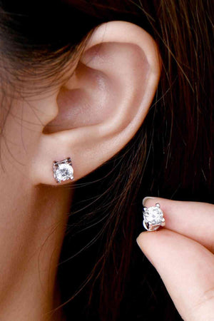 a close up of a person wearing a pair of earrings