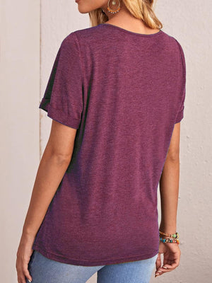 a woman wearing a purple shirt and jeans