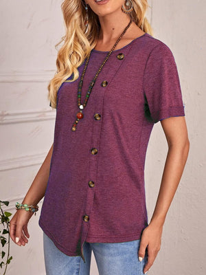 a woman wearing a purple shirt and a necklace