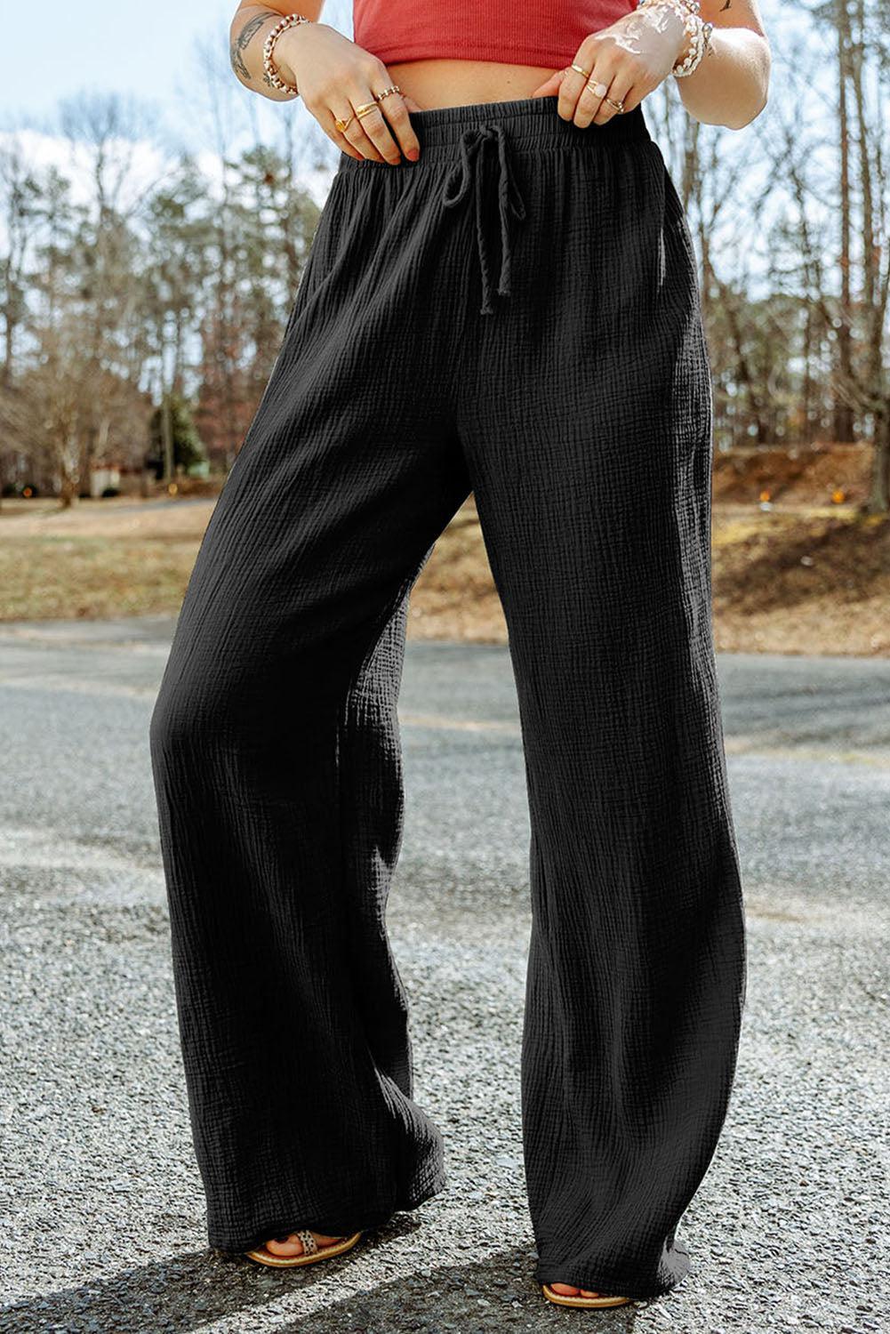 a woman in a red top and black pants