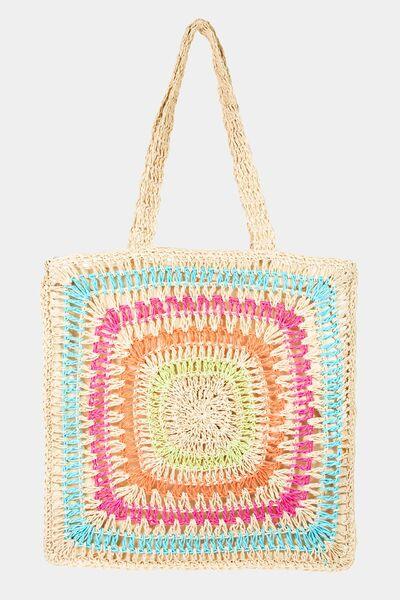 a multicolored crocheted bag hanging on a wall