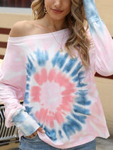 a woman wearing a pink and blue tie - dye top