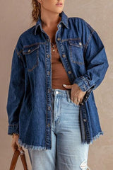 a woman wearing a denim jacket and jeans holding a handbag