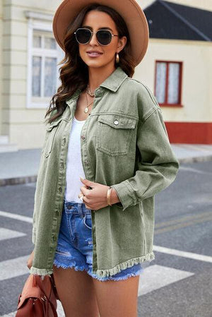 a woman wearing a hat and green jacket