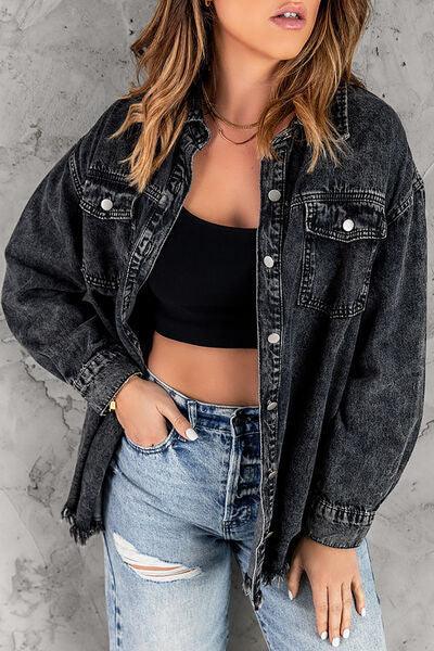 a woman wearing a black crop top and denim jacket