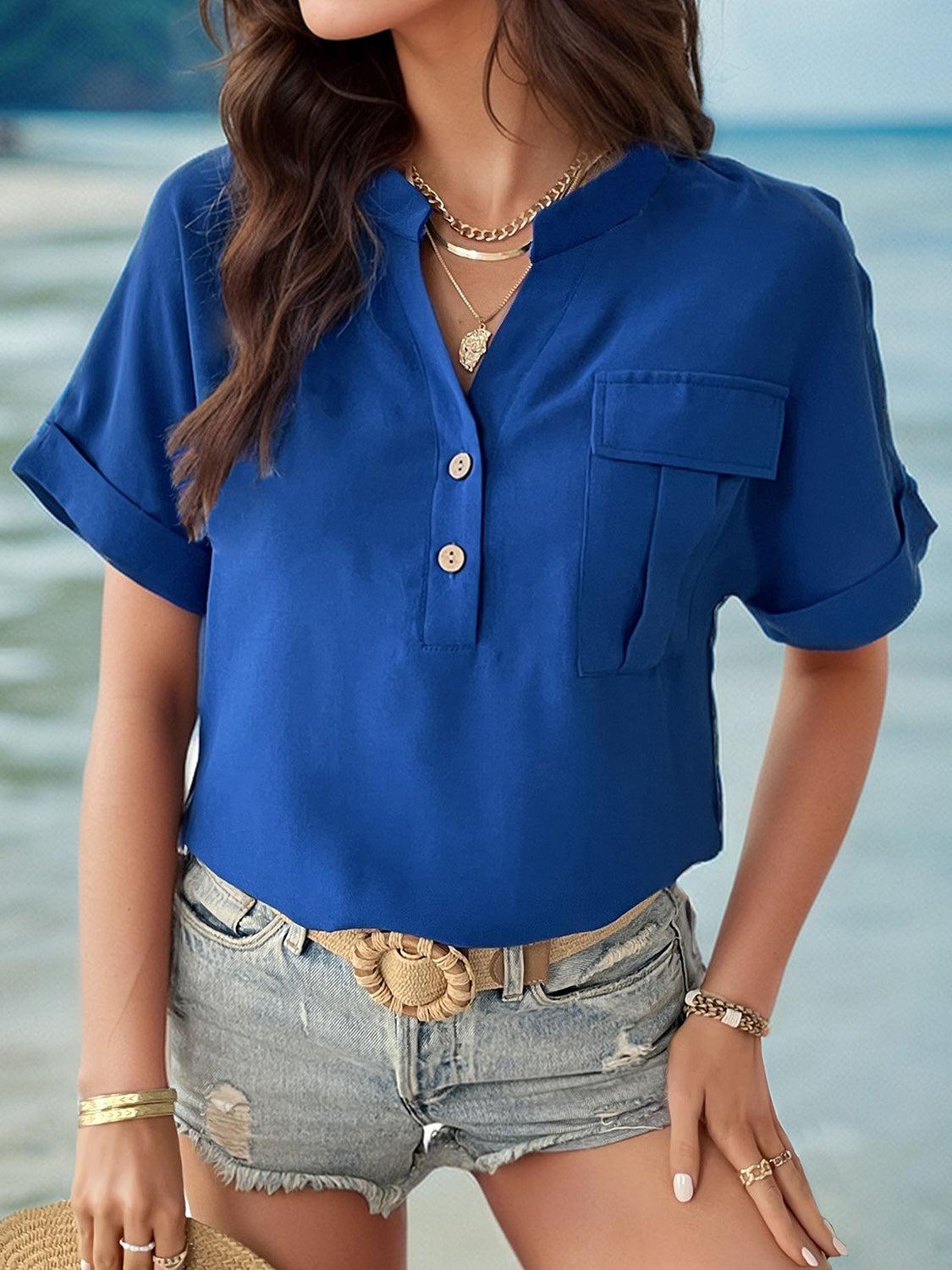 a woman wearing a blue shirt and shorts