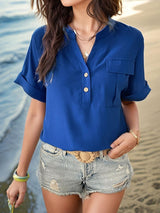 a woman standing on a beach next to the ocean