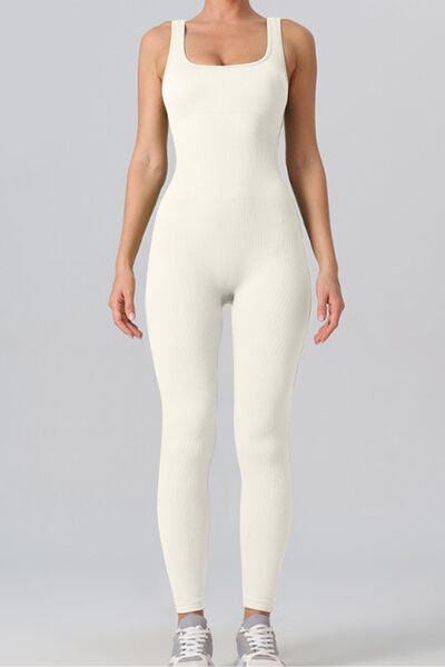 a woman wearing a white bodysuit and sneakers