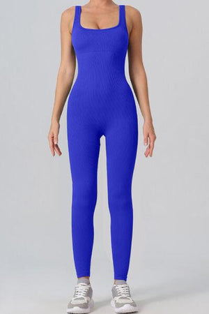 a woman in a blue bodysuit posing for a picture