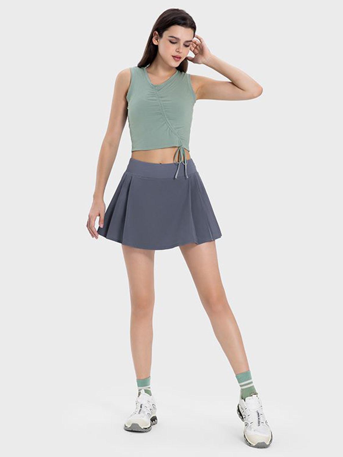 a woman in a short skirt and crop top