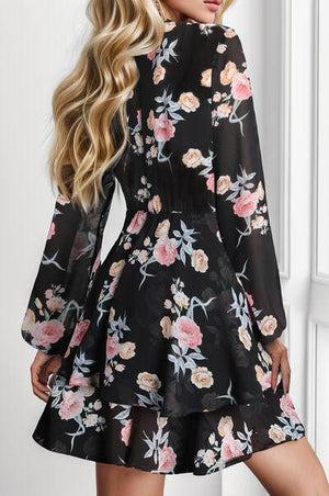 a woman wearing a black floral print dress