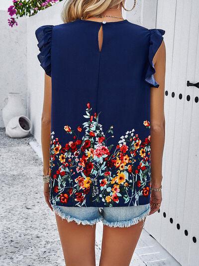 a woman wearing a blue top with flowers on it