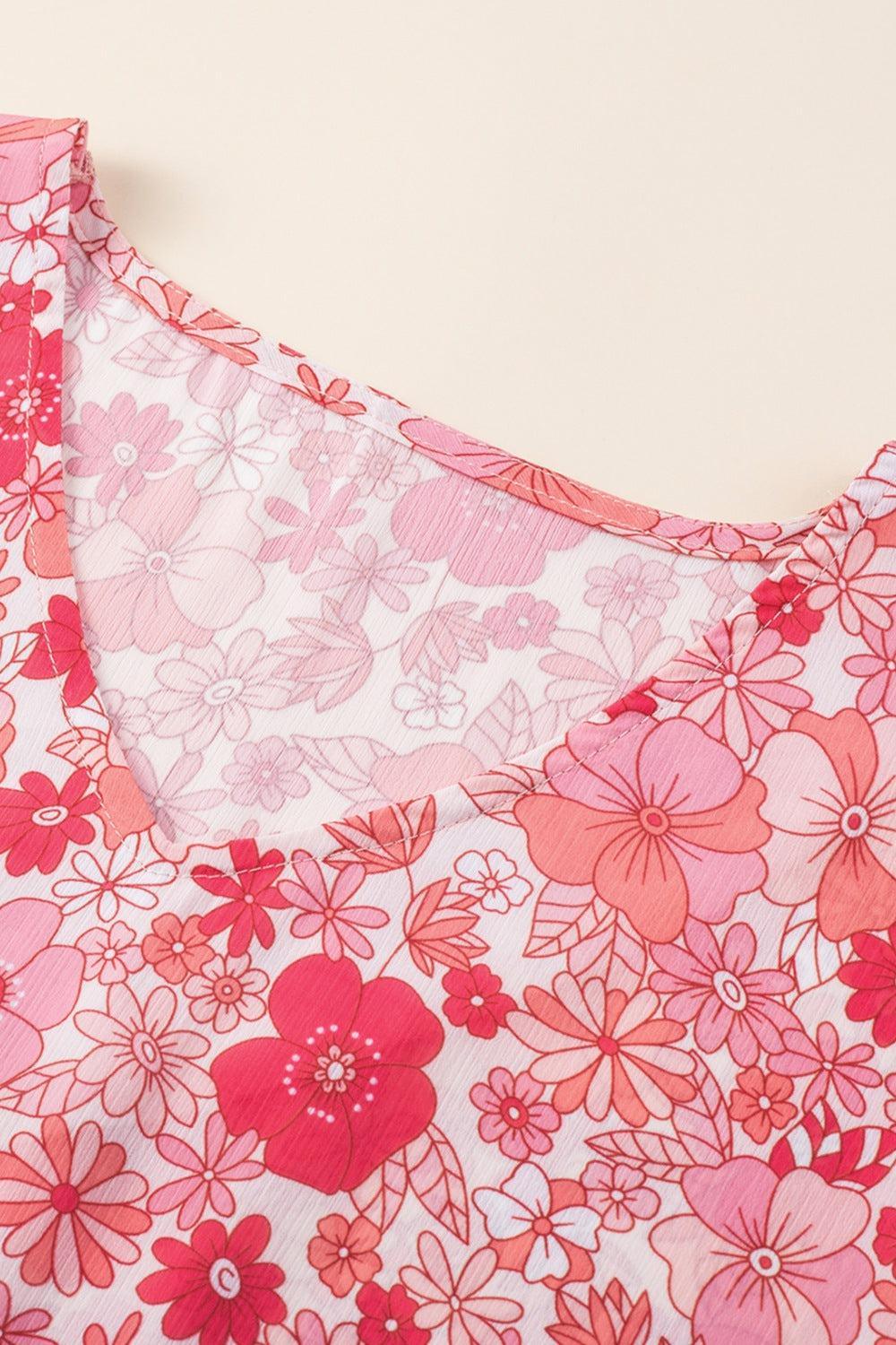 a close up of a pink and red flowered dress