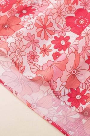 a close up of a pink and red flowered fabric