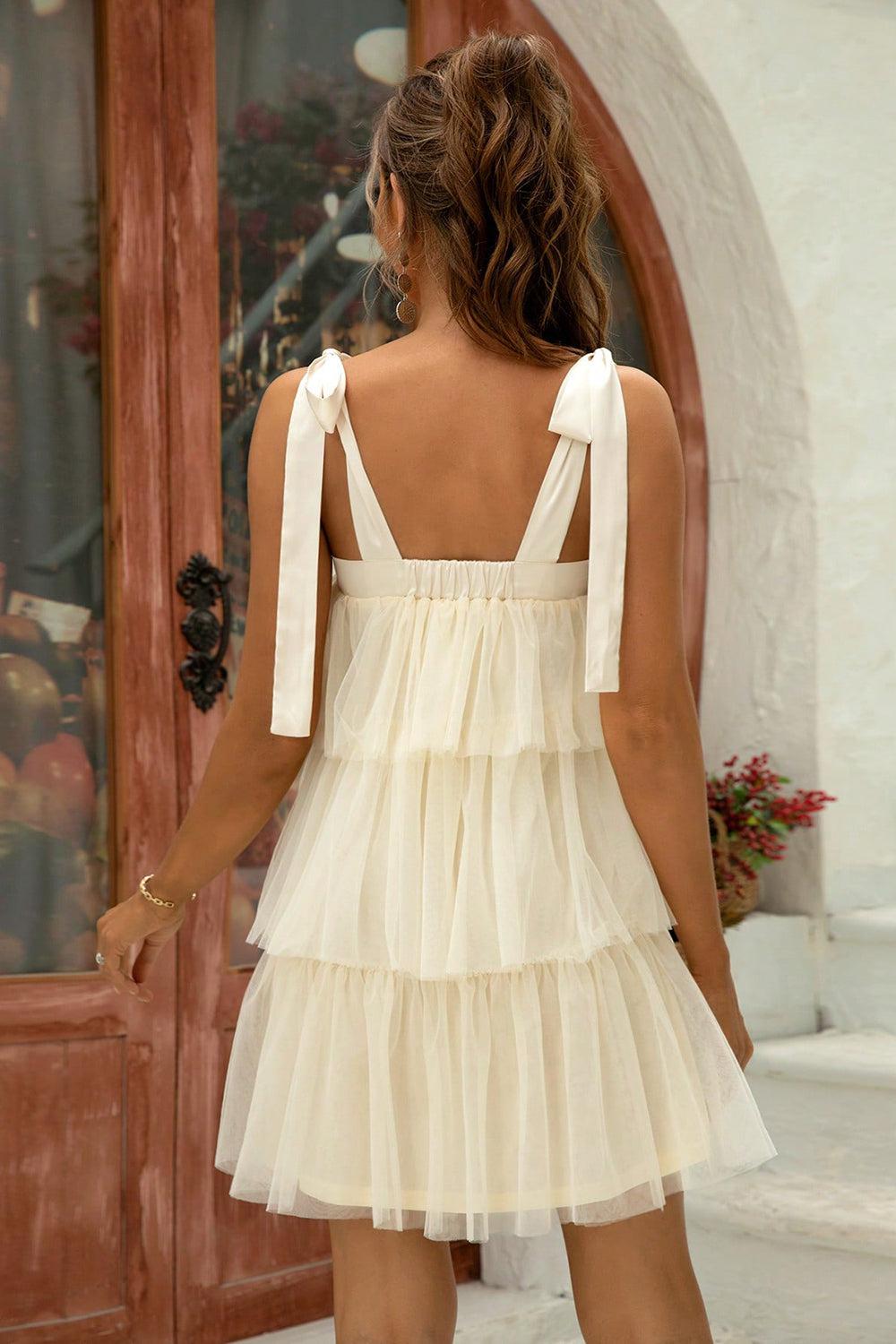 the back of a woman's dress with a bow at the neck