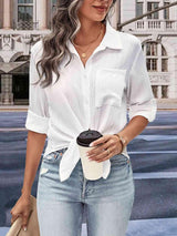 a woman in a white shirt and jeans holding a coffee cup