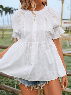 a woman standing in front of a fence