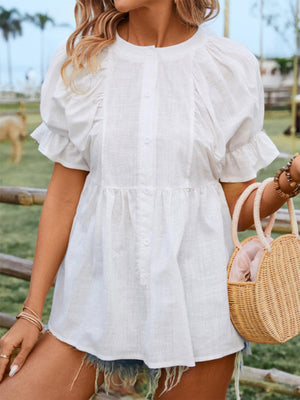 a woman in a white dress holding a straw bag