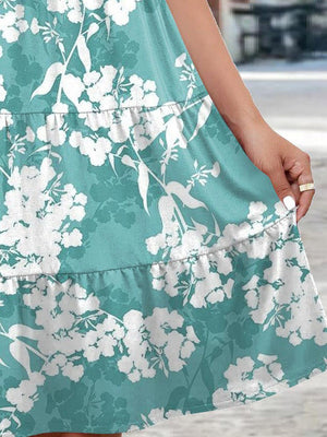 a woman in a blue and white floral dress