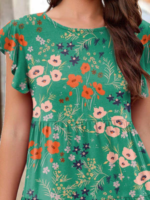 a woman wearing a green floral top