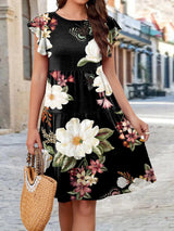a woman in a black floral print dress