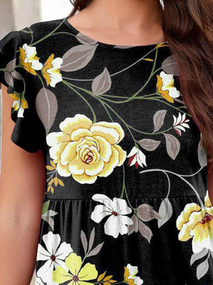 a woman wearing a black and yellow floral dress