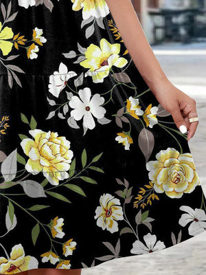 a woman in a black dress with yellow and white flowers