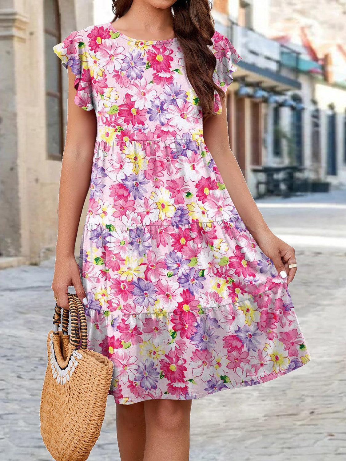 a woman in a floral dress holding a straw bag