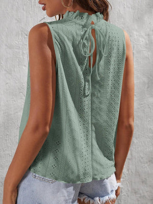 a woman wearing a green top with holes on it