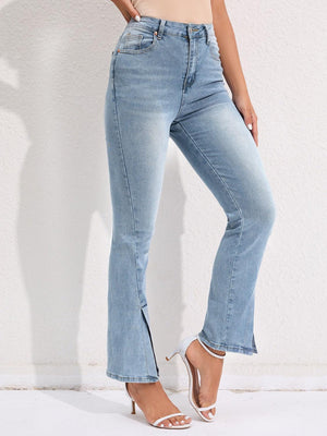 a woman in high rise jeans poses for a picture