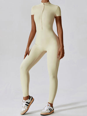 a woman in a white bodysuit posing for a picture