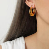 a close up of a person wearing a pair of earrings