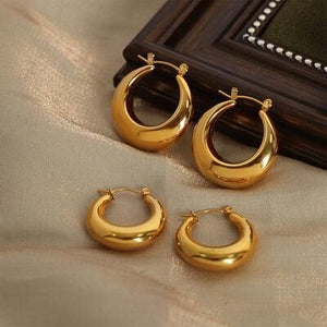 three pairs of shiny gold hoop earrings