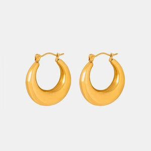 a pair of yellow hoop earrings on a white background