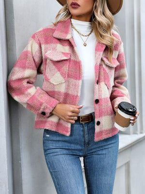 a woman wearing a pink and white jacket and hat