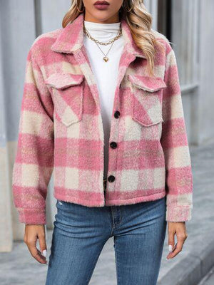 a woman wearing a pink and white checkered jacket