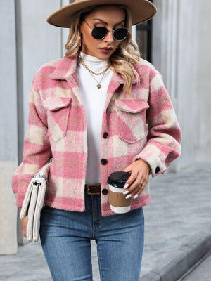 a woman wearing a pink and white checkered coat