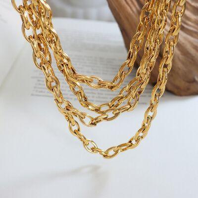 a close up of a gold necklace on a table