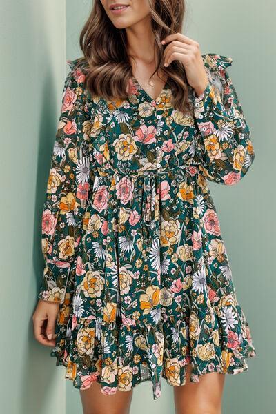 a woman posing for a picture in a floral dress