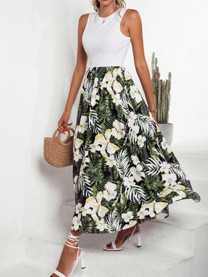 a woman in a white top and a tropical print skirt