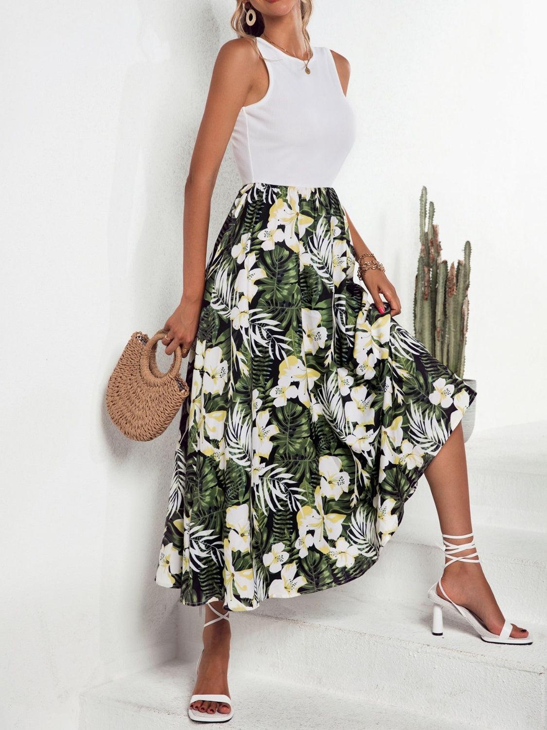 a woman in a white top and a tropical print skirt