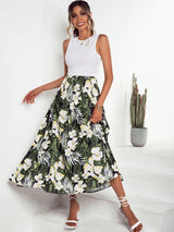 a woman in a white top and a floral print skirt