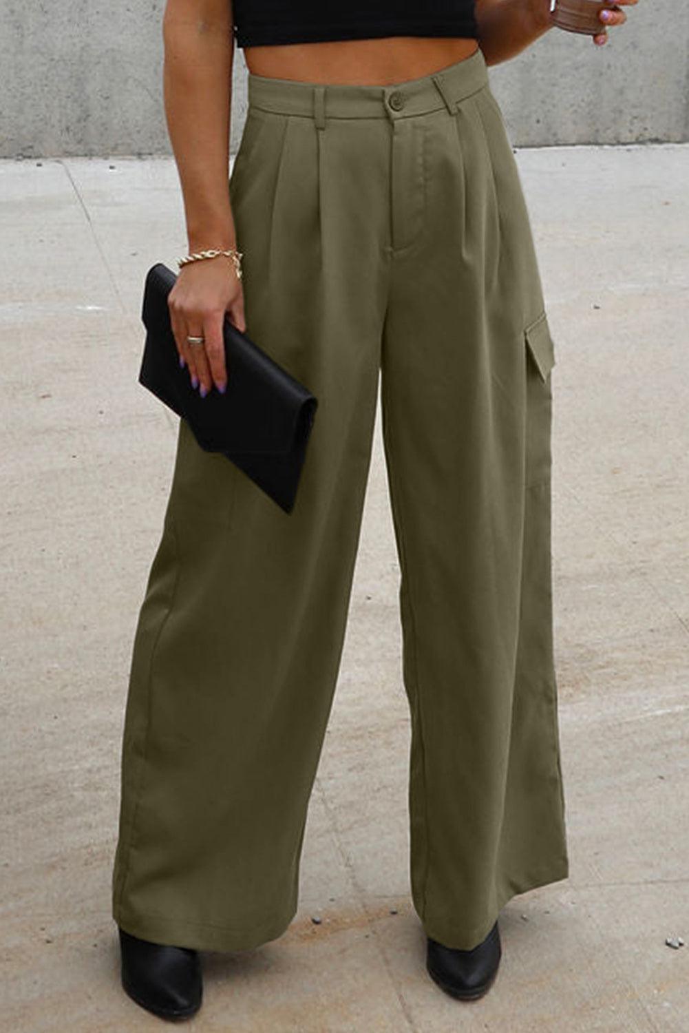 a woman standing on a sidewalk holding a cell phone